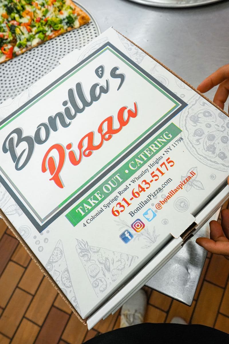Bonilla's Pizza box with the phone number and address printed on the lid