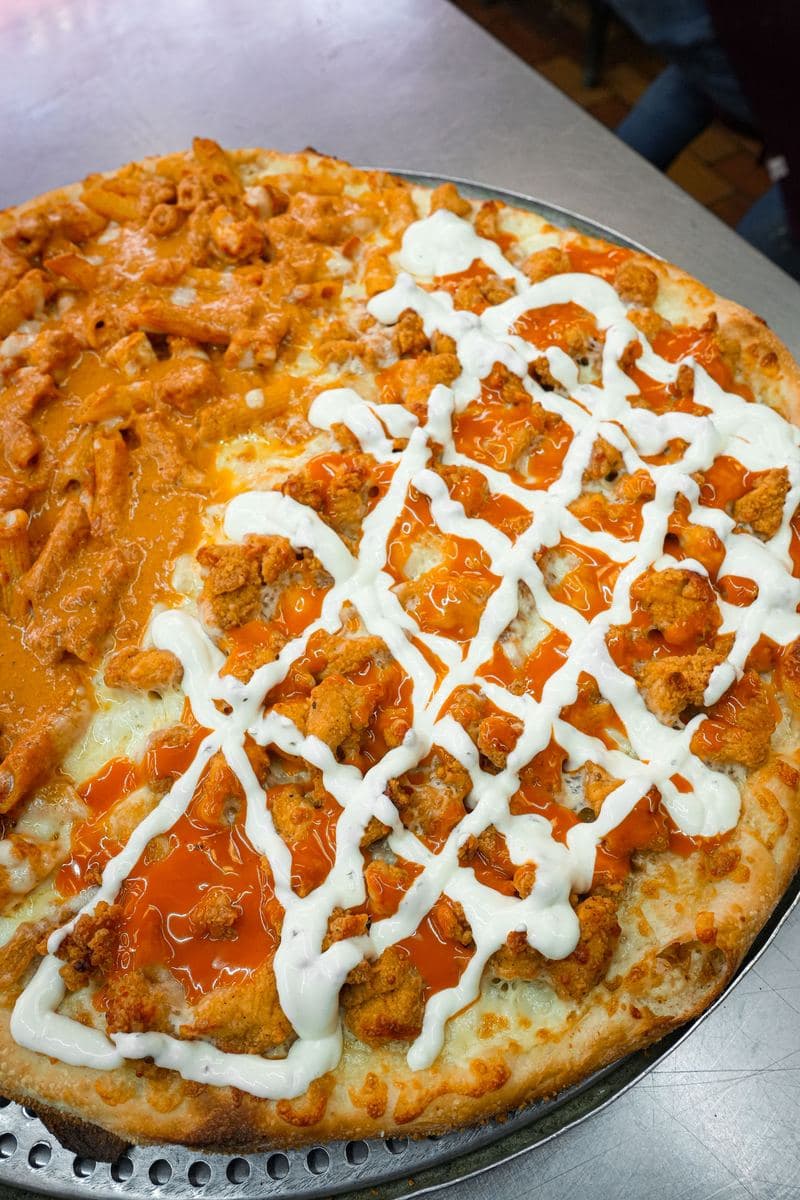 Buffalo chicken pizza finished with a lattice of ranch dressing