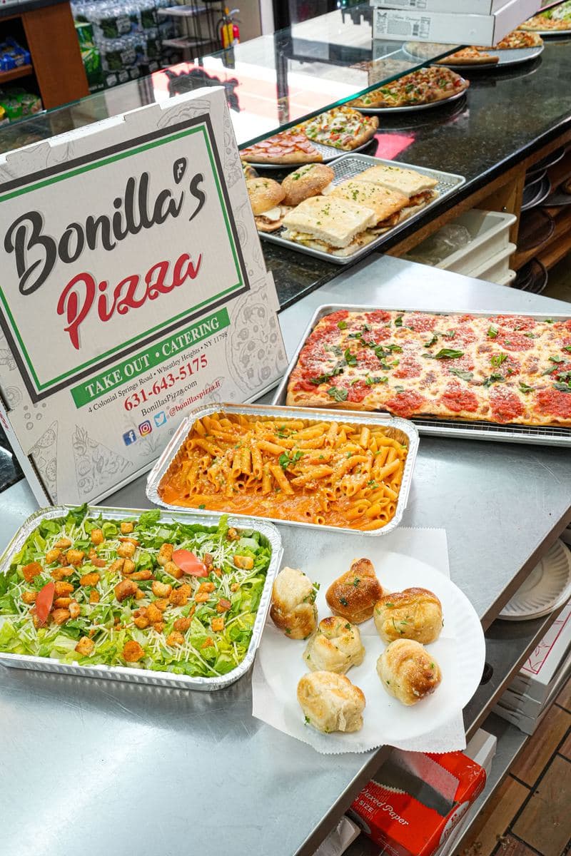 Full catering spread: salad, penne alla vodka, Sicilian tray and heroes