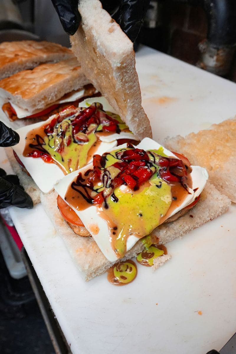 Chicken cutlet on focaccia with fresh mozzarella, roasted peppers and balsamic