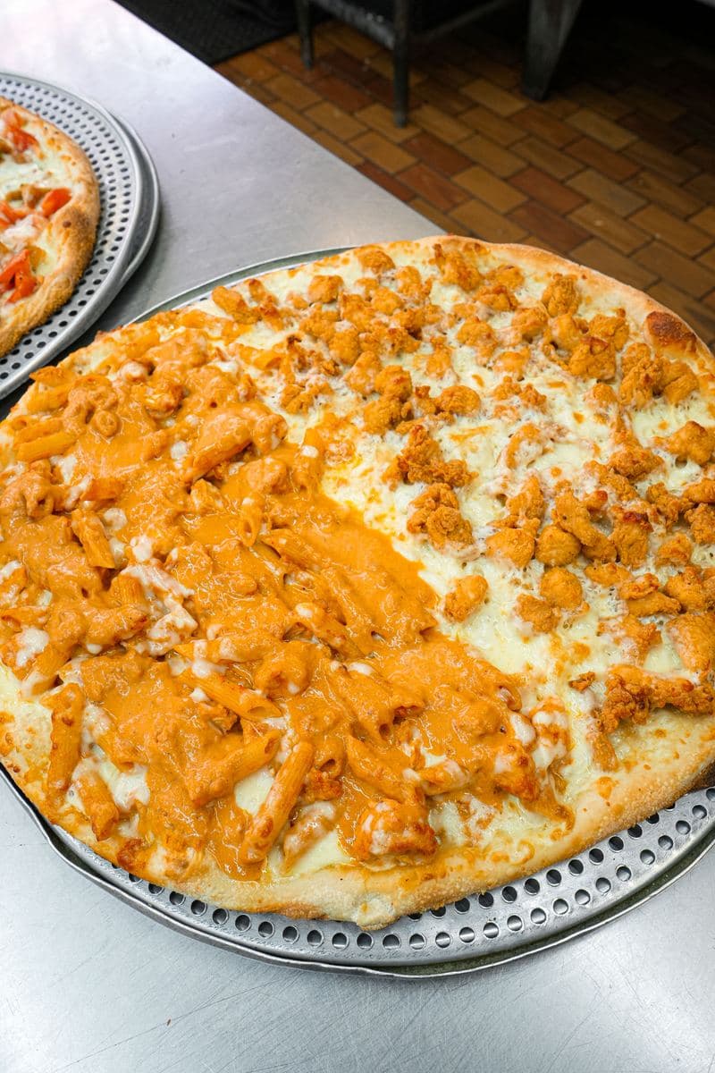 Chicken penne alla vodka pizza, penne and chicken baked over mozzarella