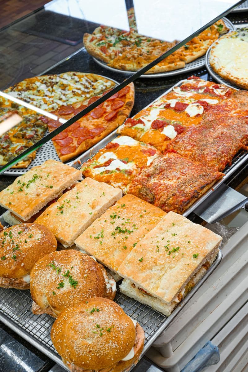 Display case at Bonilla's with pies, garlic knots and focaccia heroes