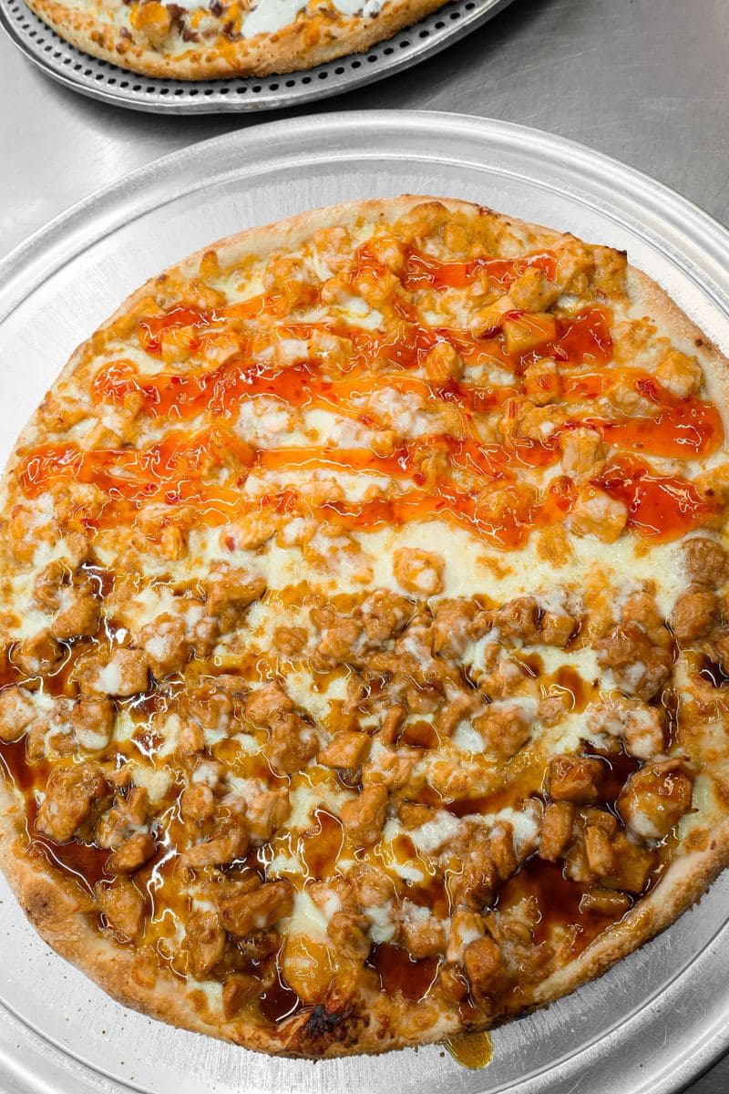 Half-and-half pizza, buffalo chicken on one side and BBQ chicken on the other