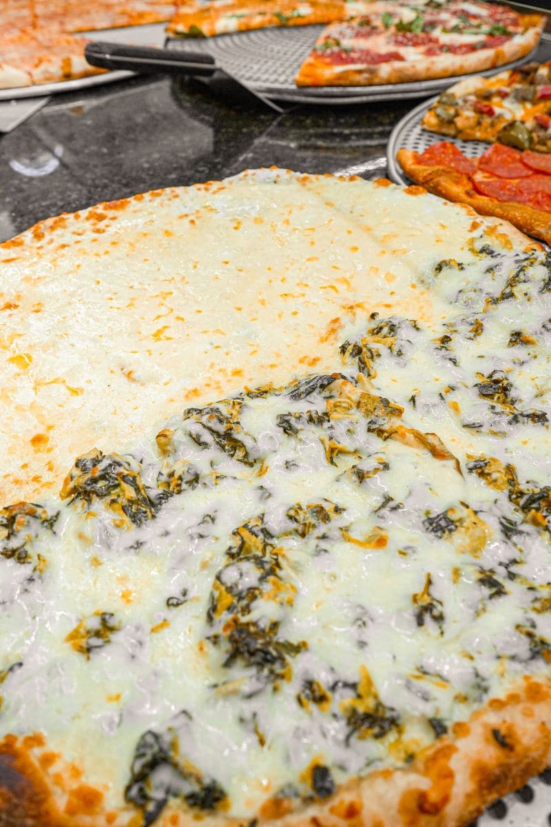 Close-up of the spinach half of a white pie