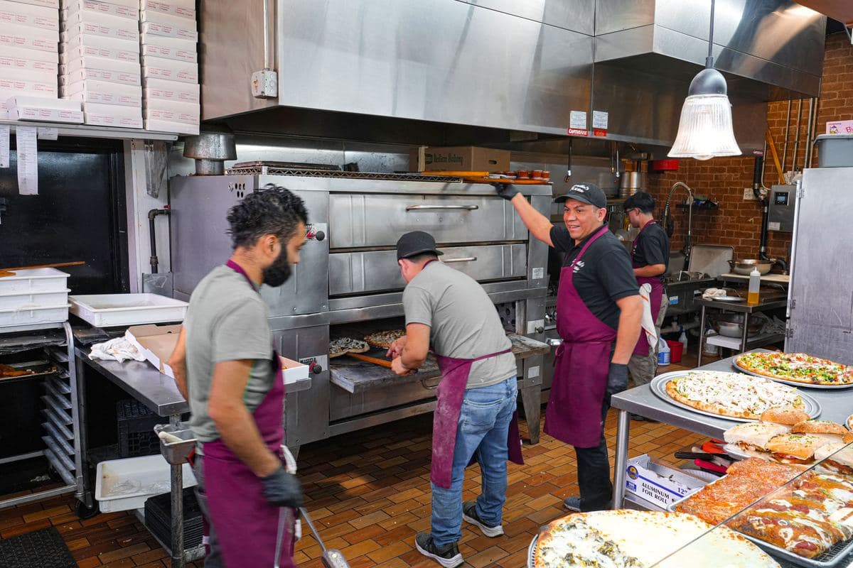 The Bonilla's kitchen crew at the deck oven during a rush