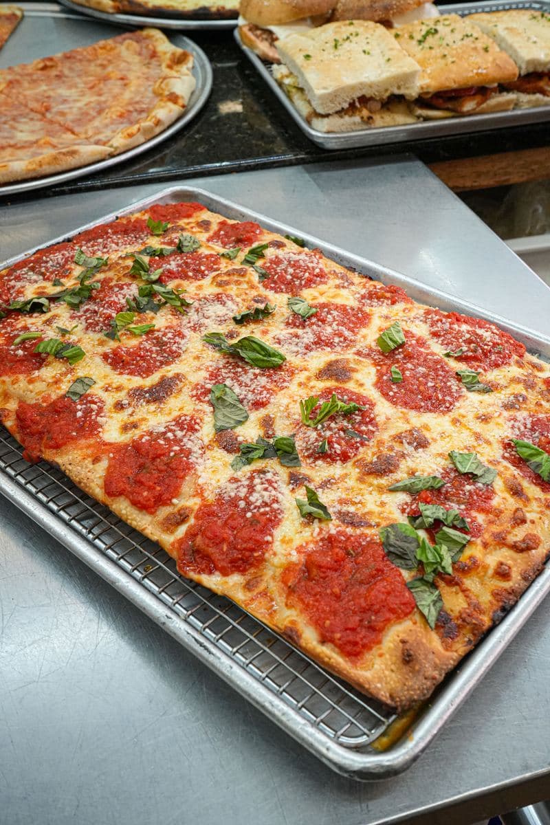 Margherita Sicilian with crushed tomato and basil, cooling on a rack