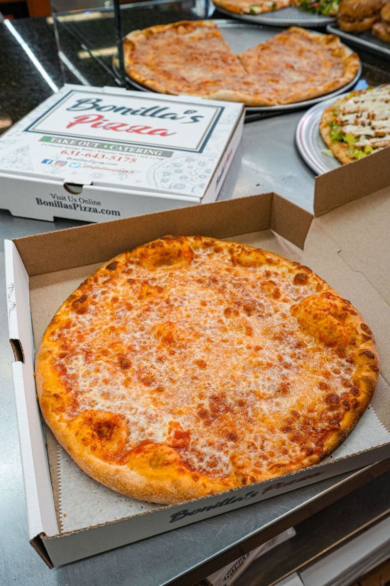 Personal cheese pie in a takeout box, seen from above