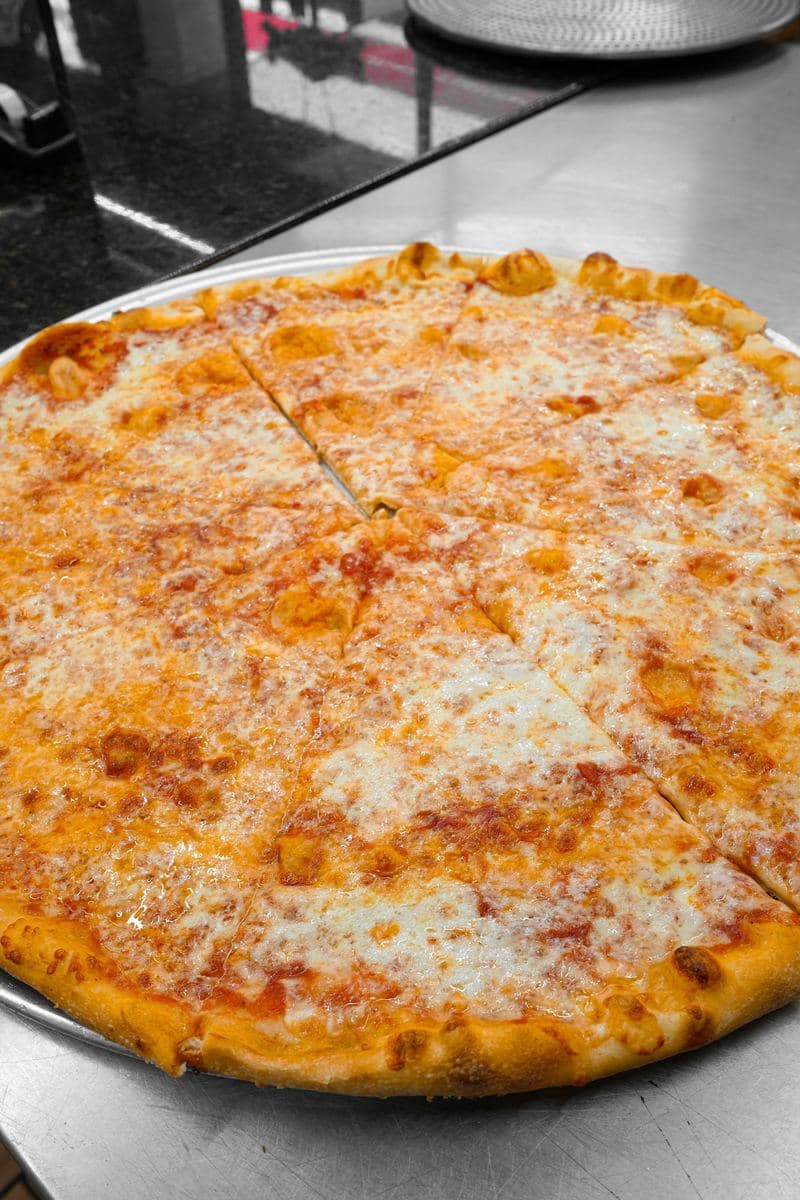 A 16-inch Bonilla's cheese pie sliced on a metal pan, seen from above