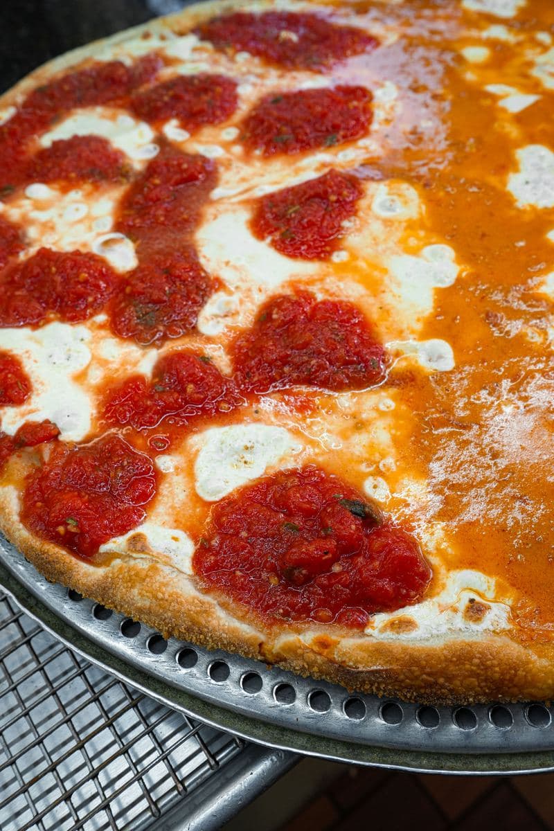 Close-up of vodka sauce, fresh mozzarella and crushed tomato on a Bonilla's pie